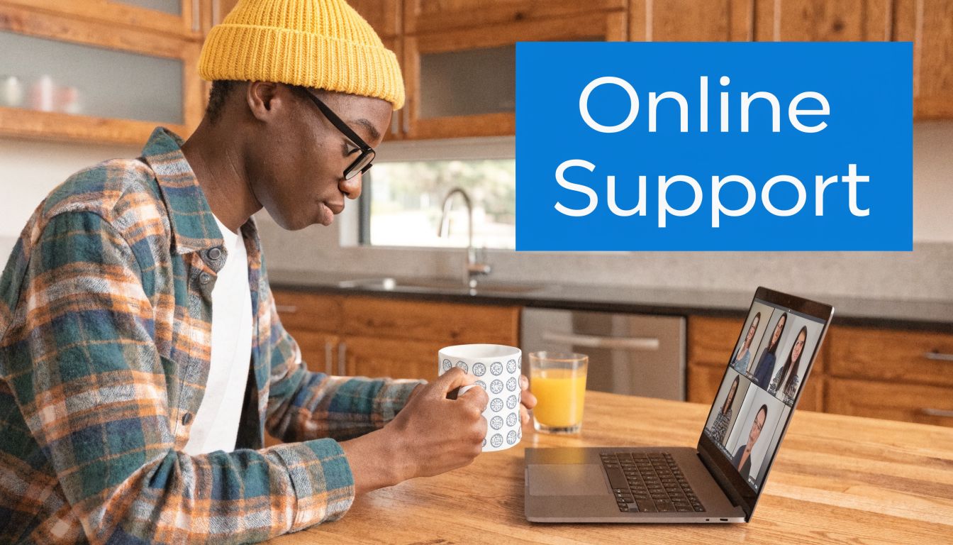 A young man with a yellow beanie participating in an online video call on his laptop.