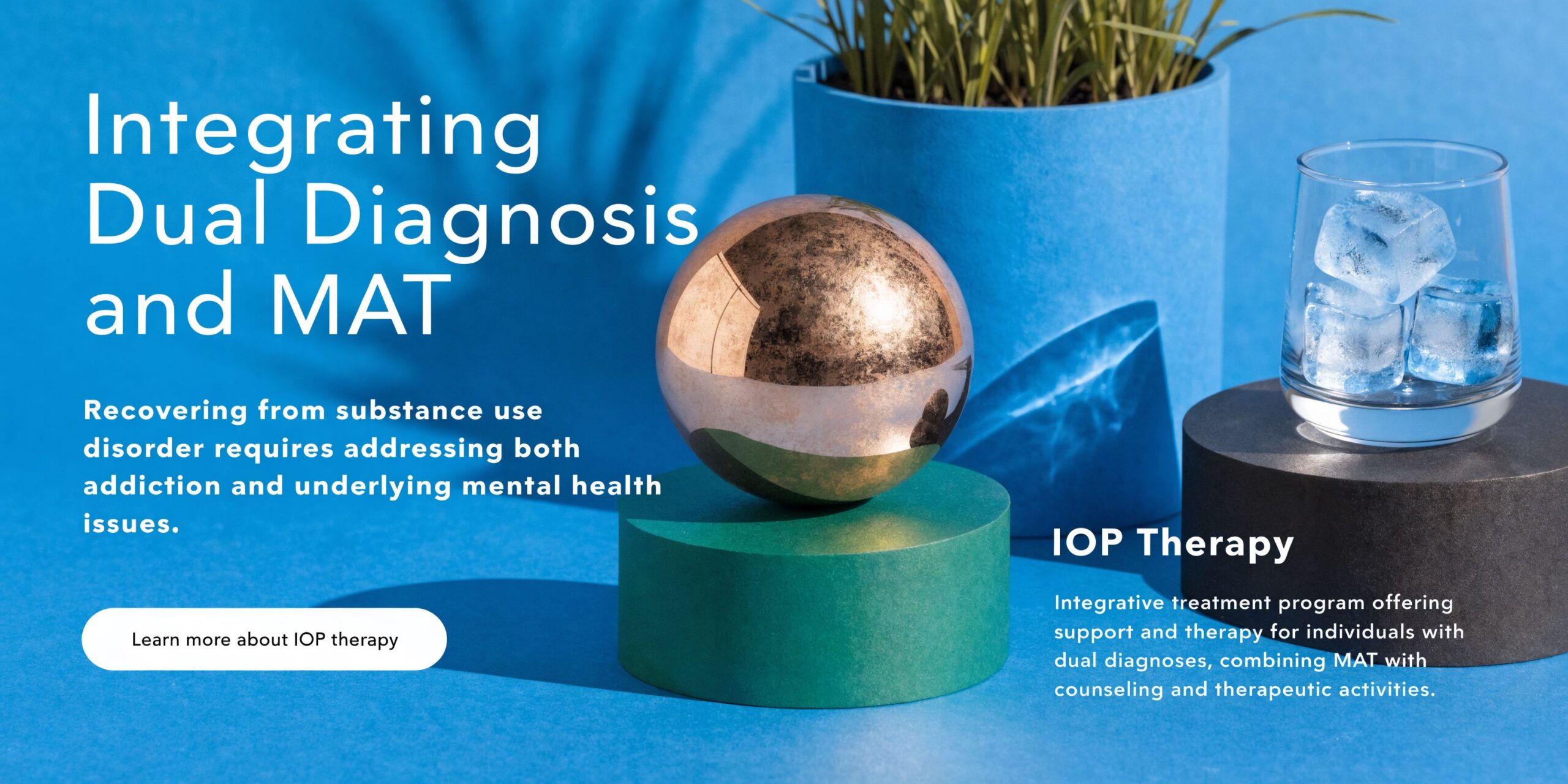 A conceptual studio image showing a metallic sphere and a glass with ice to illustrate dual diagnosis treatment.